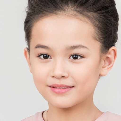 Joyful white child female with short  brown hair and brown eyes