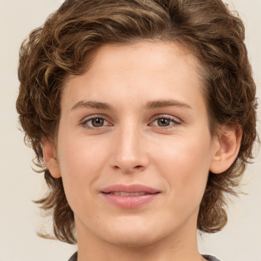 Joyful white young-adult female with medium  brown hair and green eyes