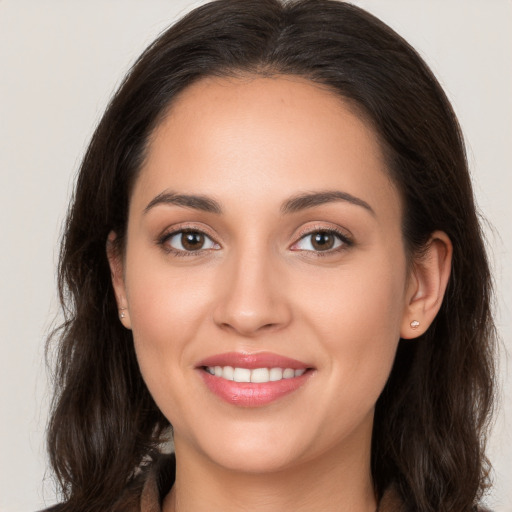 Joyful white young-adult female with long  brown hair and brown eyes