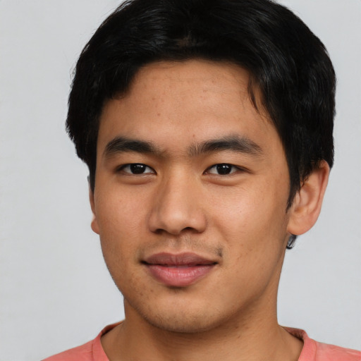 Joyful asian young-adult male with short  brown hair and brown eyes