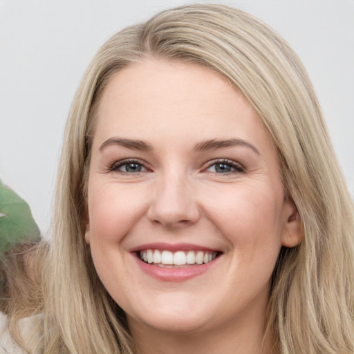 Joyful white young-adult female with long  brown hair and green eyes