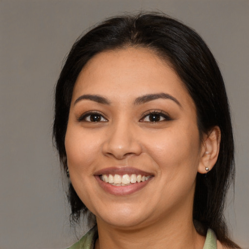 Joyful latino young-adult female with medium  black hair and brown eyes