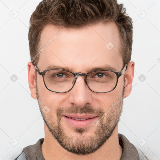 Joyful white adult male with short  brown hair and grey eyes