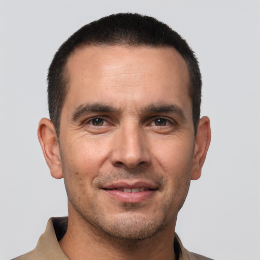 Joyful white young-adult male with short  black hair and brown eyes