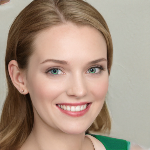 Joyful white young-adult female with long  brown hair and blue eyes