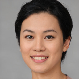 Joyful asian young-adult female with medium  black hair and brown eyes