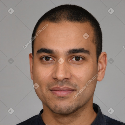 Joyful latino young-adult male with short  black hair and brown eyes