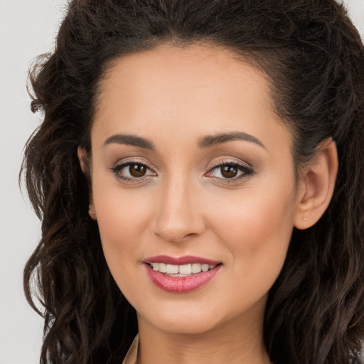 Joyful white young-adult female with long  brown hair and brown eyes