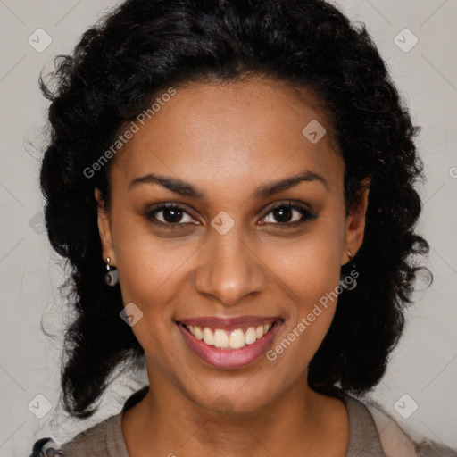 Joyful black young-adult female with long  brown hair and brown eyes