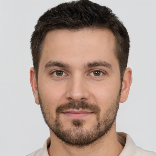 Joyful white young-adult male with short  brown hair and brown eyes