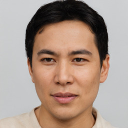 Joyful asian young-adult male with short  black hair and brown eyes