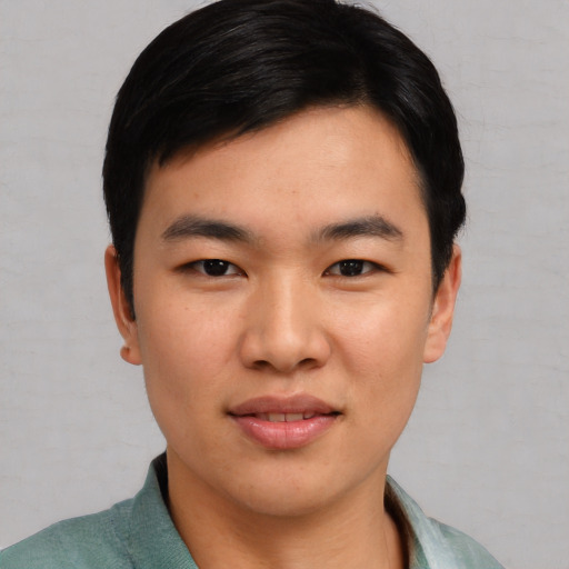 Joyful asian young-adult male with short  black hair and brown eyes