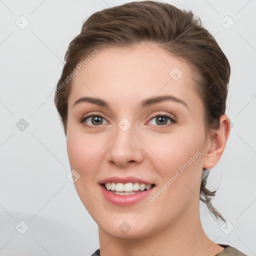 Joyful white young-adult female with medium  brown hair and grey eyes