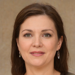 Joyful white young-adult female with long  brown hair and green eyes