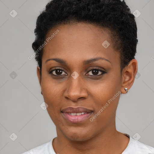 Joyful black young-adult female with short  black hair and brown eyes