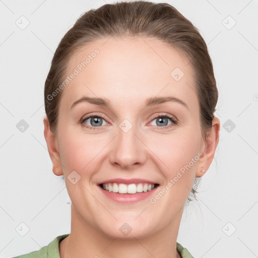 Joyful white young-adult female with medium  brown hair and green eyes