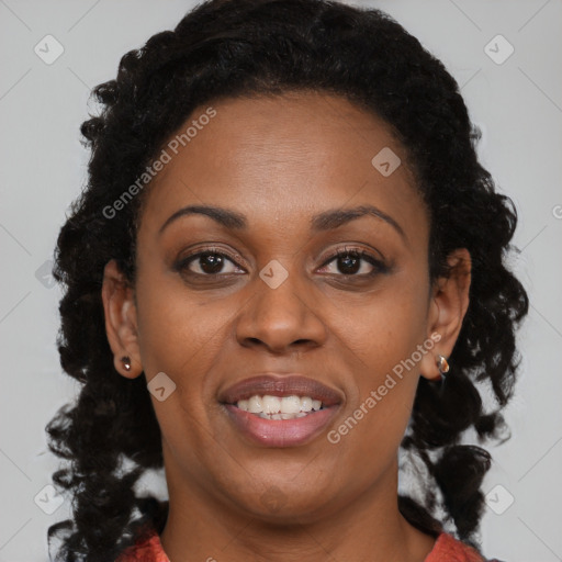 Joyful black adult female with long  brown hair and brown eyes