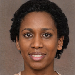 Joyful black young-adult female with short  black hair and brown eyes