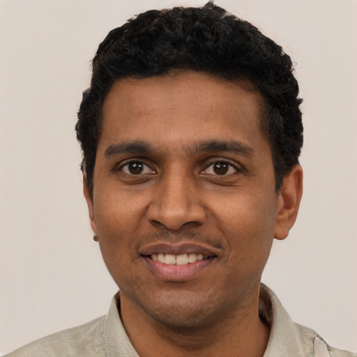 Joyful black young-adult male with short  black hair and brown eyes