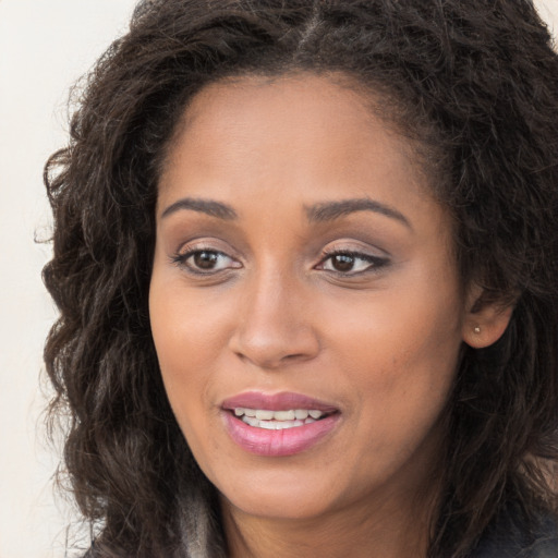 Joyful white young-adult female with long  brown hair and brown eyes