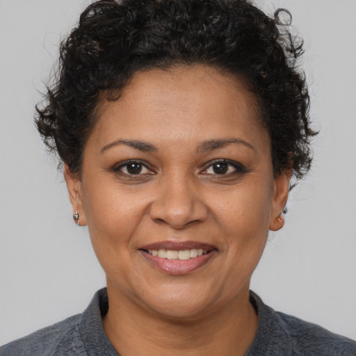 Joyful latino young-adult female with short  brown hair and brown eyes