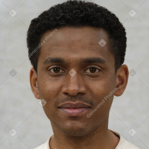 Joyful black young-adult male with short  black hair and brown eyes