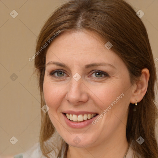 Joyful white adult female with medium  brown hair and brown eyes