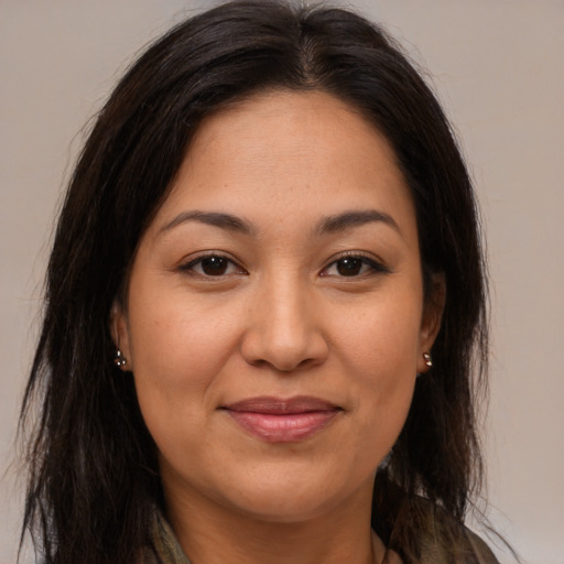 Joyful latino young-adult female with medium  brown hair and brown eyes