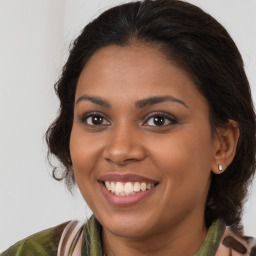 Joyful black young-adult female with medium  brown hair and brown eyes