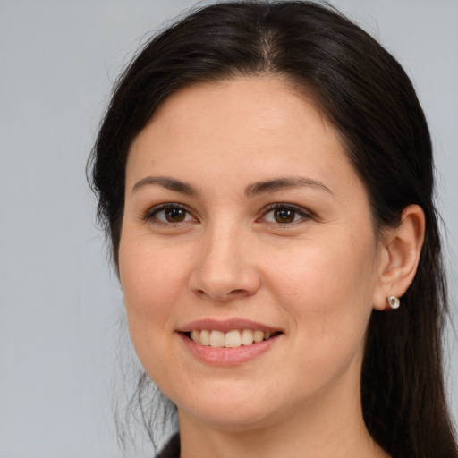 Joyful white young-adult female with long  brown hair and brown eyes