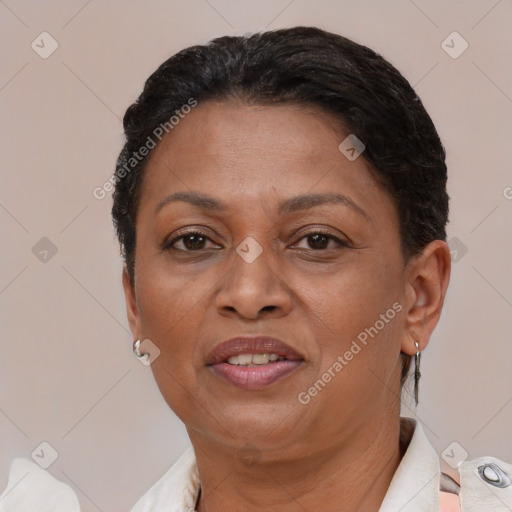 Joyful black adult female with short  brown hair and brown eyes