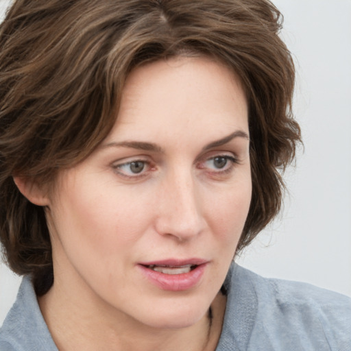 Joyful white young-adult female with medium  brown hair and blue eyes