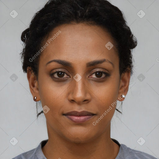 Joyful black young-adult female with short  black hair and brown eyes