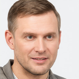 Joyful white adult male with short  brown hair and grey eyes