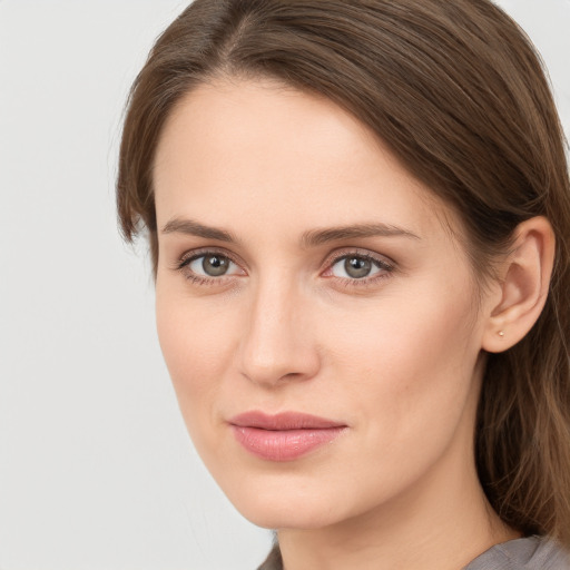 Joyful white young-adult female with long  brown hair and grey eyes