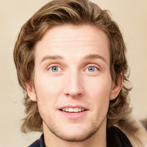 Joyful white young-adult male with short  brown hair and blue eyes