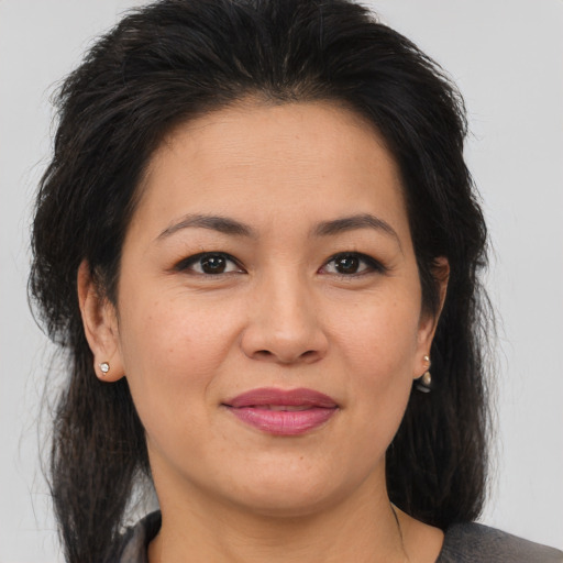 Joyful asian adult female with medium  brown hair and brown eyes