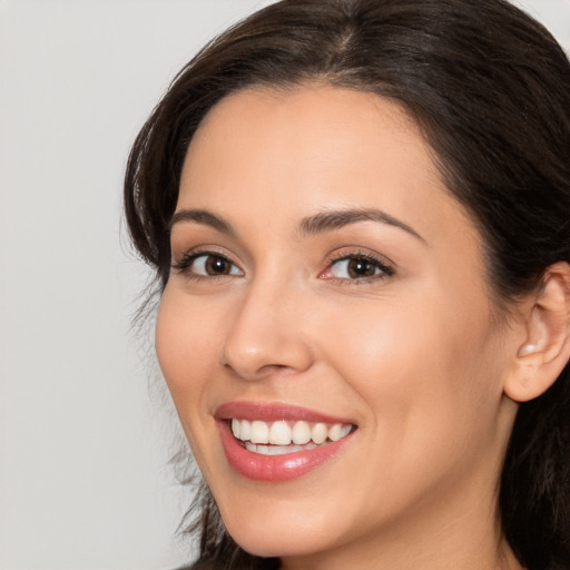 Joyful white young-adult female with long  brown hair and brown eyes