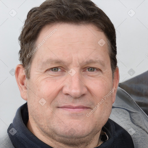 Joyful white adult male with short  brown hair and grey eyes