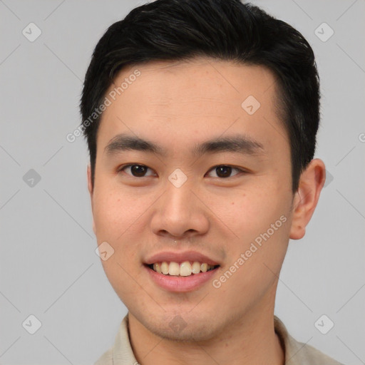 Joyful asian young-adult male with short  black hair and brown eyes