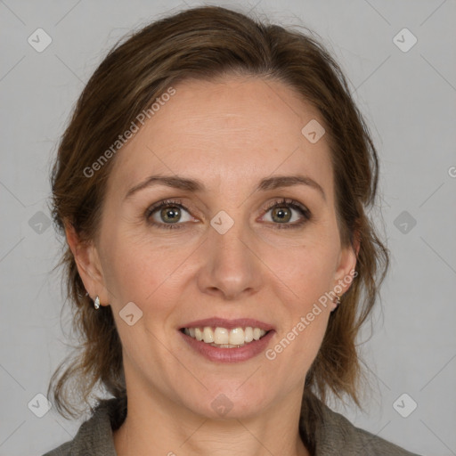 Joyful white adult female with medium  brown hair and grey eyes