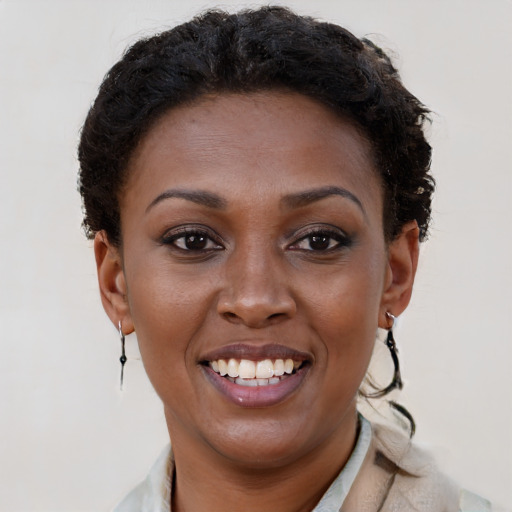 Joyful black young-adult female with short  brown hair and brown eyes
