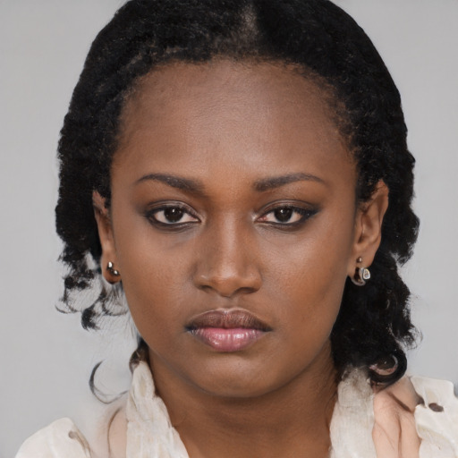 Neutral black young-adult female with medium  brown hair and brown eyes