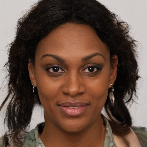 Joyful black adult female with medium  brown hair and brown eyes