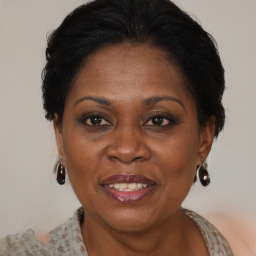 Joyful black adult female with medium  brown hair and brown eyes