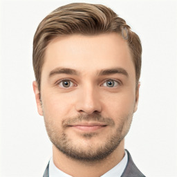 Joyful white young-adult male with short  brown hair and grey eyes