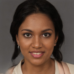 Joyful black young-adult female with medium  brown hair and brown eyes