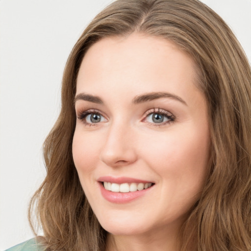 Joyful white young-adult female with long  brown hair and green eyes