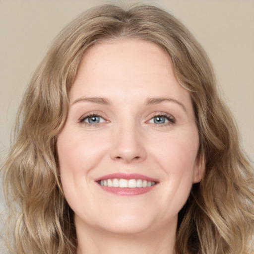 Joyful white young-adult female with medium  brown hair and green eyes