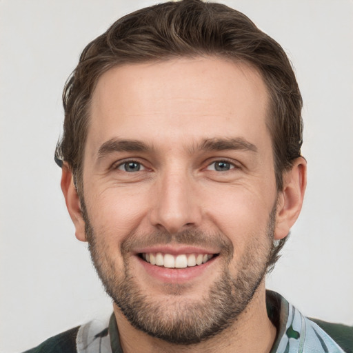 Joyful white young-adult male with short  brown hair and brown eyes